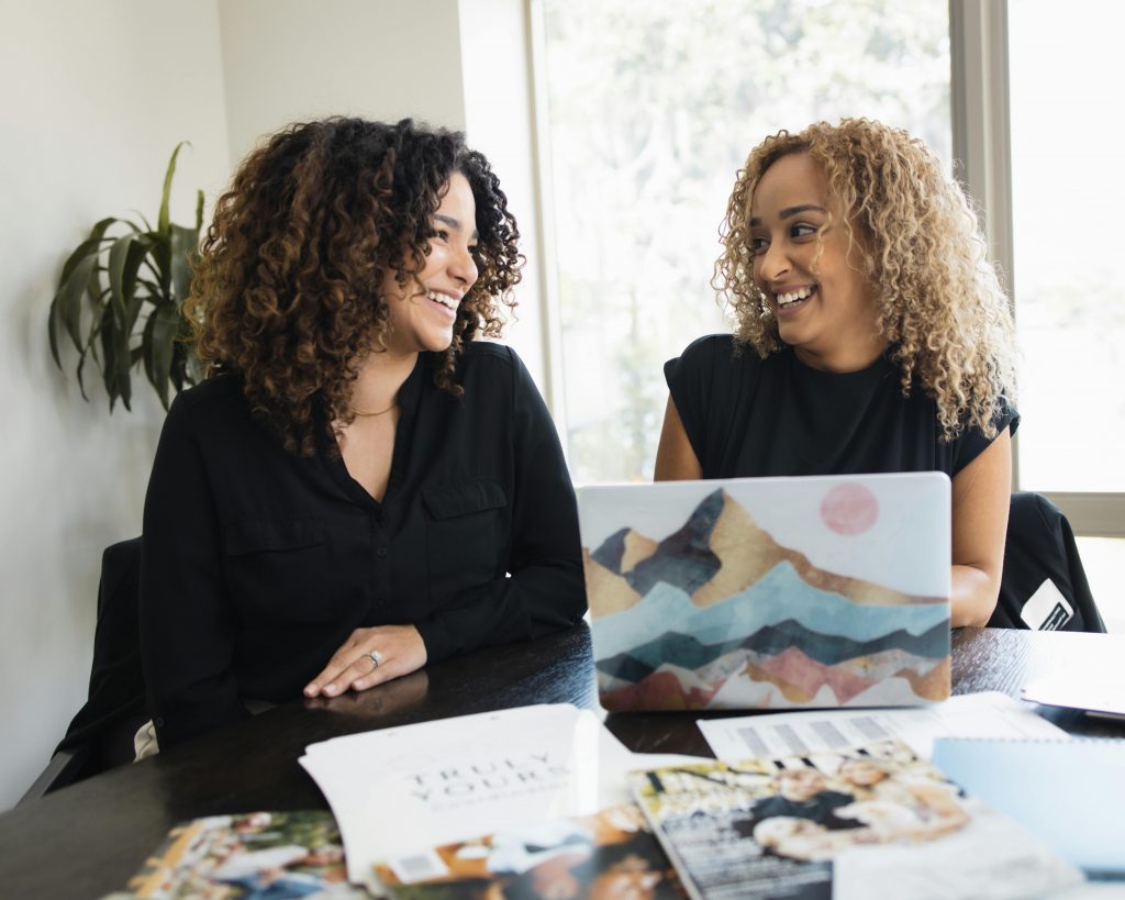 Two women having a friendly discussion at work in Orlando office
